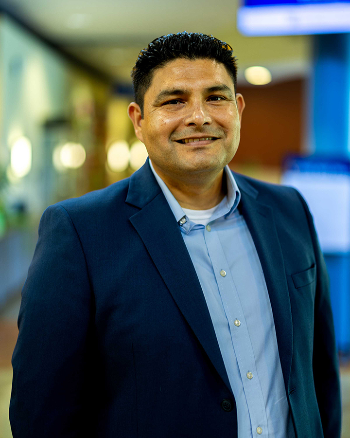 Manuel Lopez Ramirez in navy suite smiling